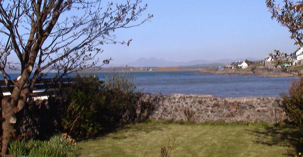 View from Dundonald cottages back garden over the sea at Islay Cottages