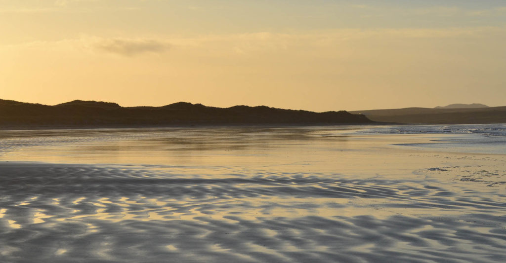 Golden sands in a beach at sunset on Islay