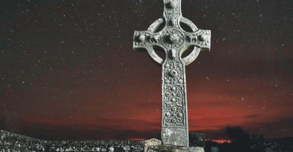 A Celtic cross on Islay with a starry sky behind it