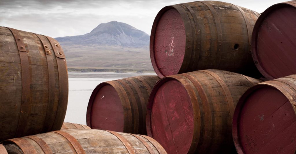 Whisky barrels with a view of Jura behind them