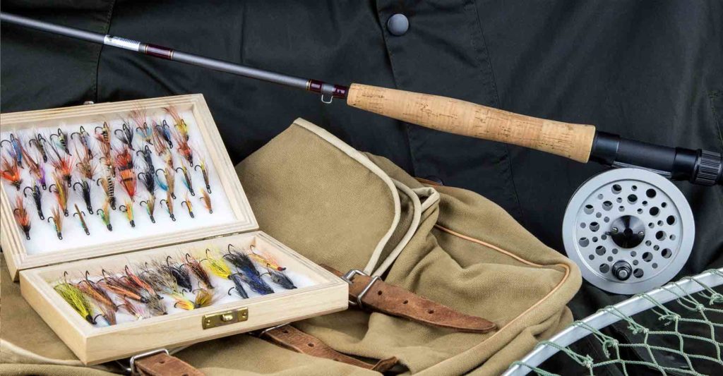 A fishing rod, fishing net, fishing satchel and fishing flies