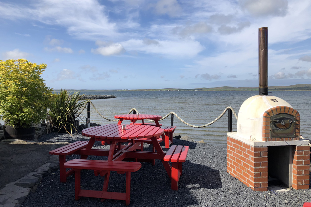 Outdoor seating area at Peatzeria, overlooking Lochindaal