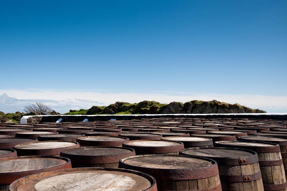 Whisky barrels underneath a blue sky on Islay.