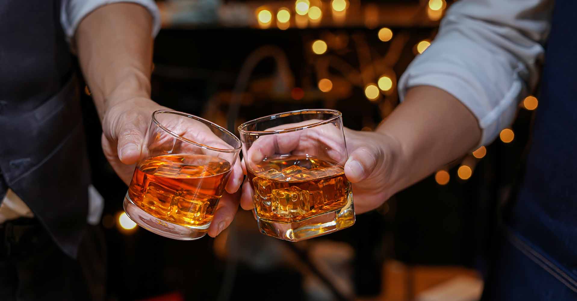 Two people toasting with whisky.